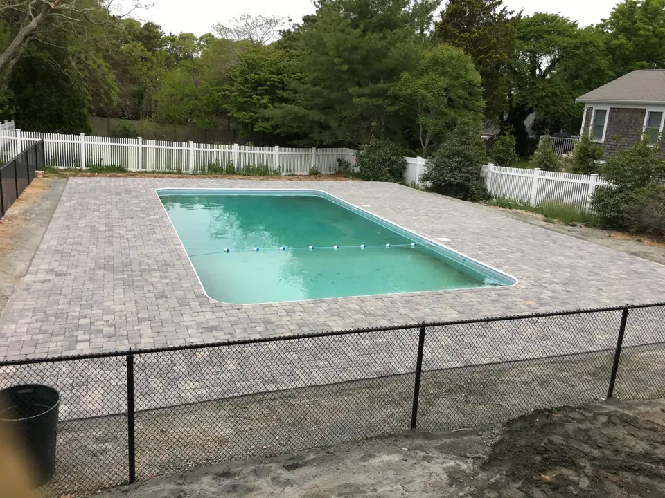 Pool with a paver deck and fence